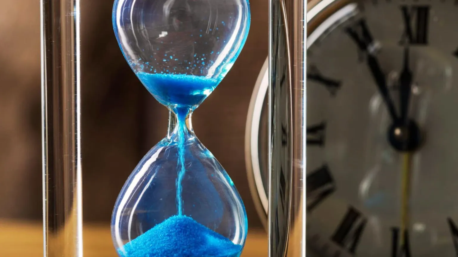 Blue hourglass clock time passing